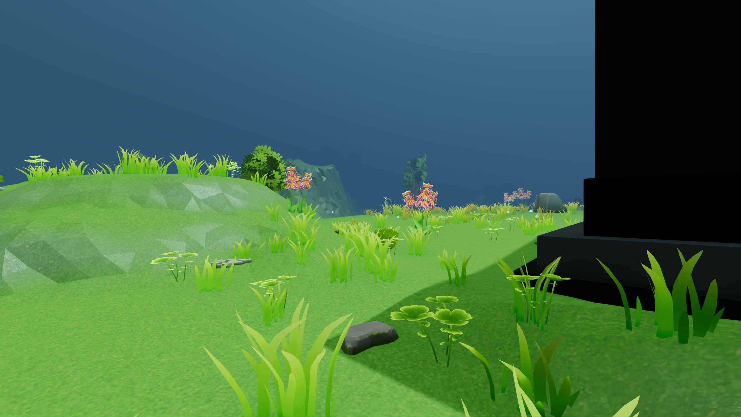 A ground-level view of green hills, grass, flowers, and a dark structure at the edge of a full-game environment, without HUD or enemies.